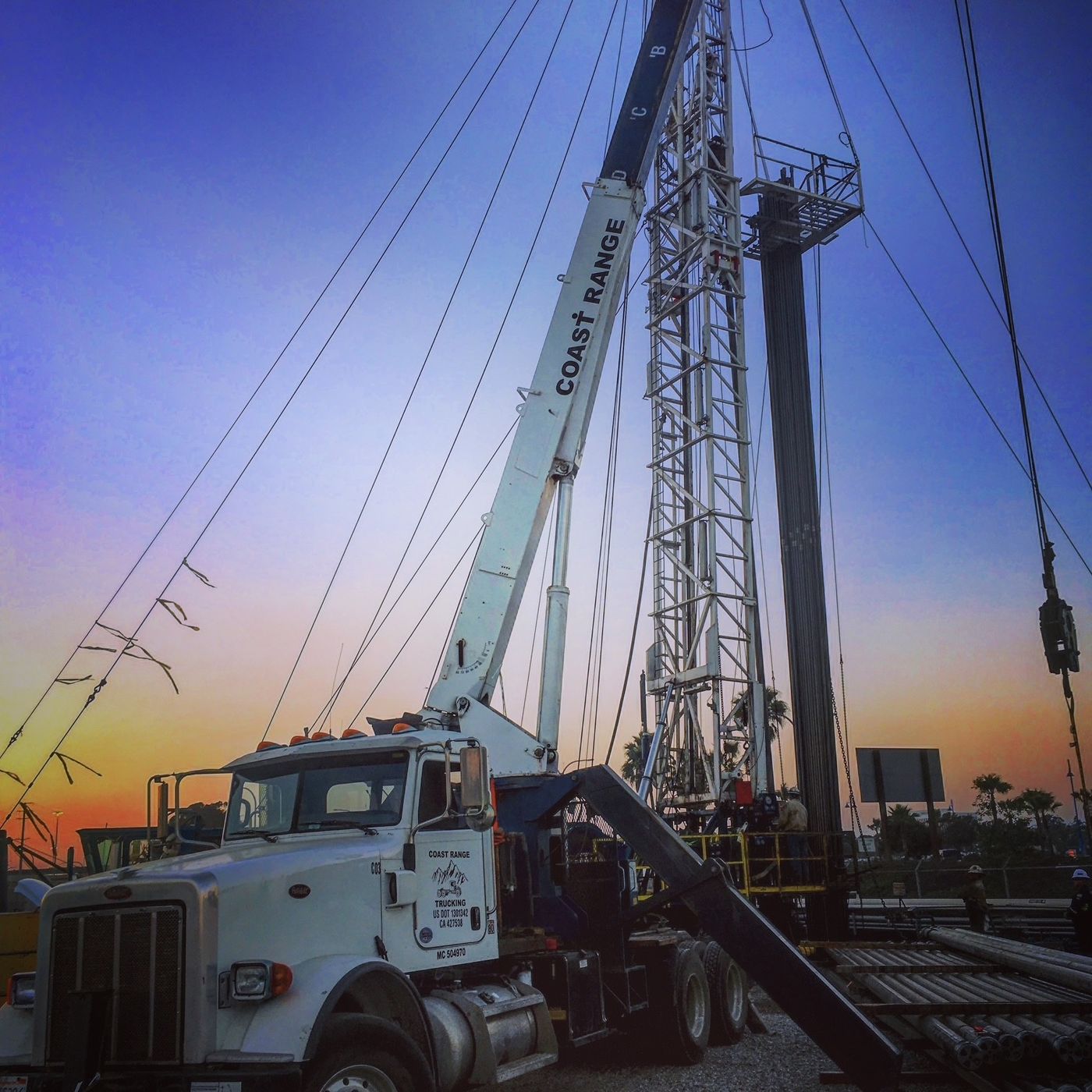A Coast Range crane truck working at dusk