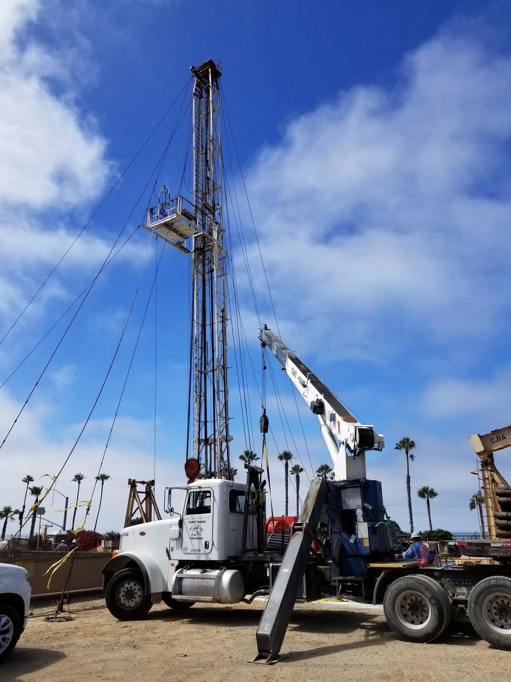 A Coast Range Trucking crane truck on an oilfield job site